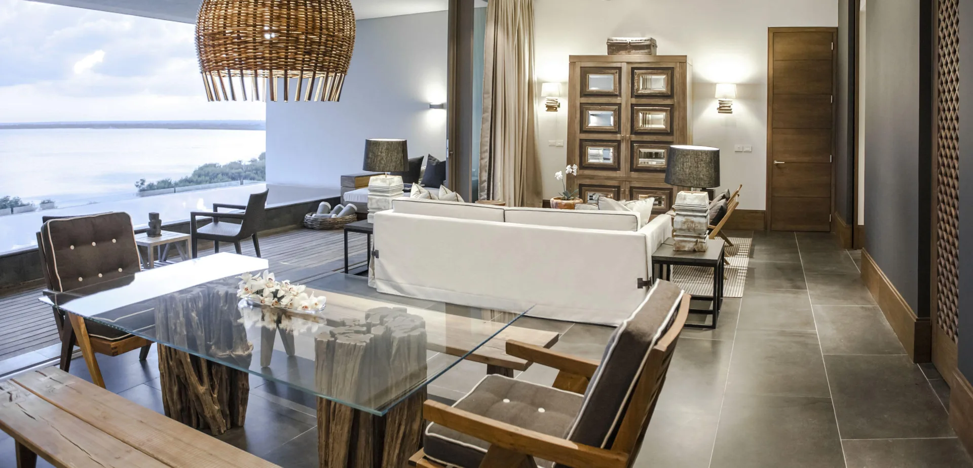 Master Suite sitting and dining area at Nizuc Resort and Spa with glass table and terrace view.