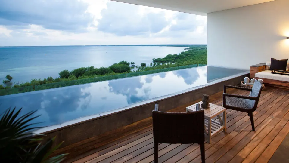 Master Suite terrace at Nizuc Resort and Spa with plunge pool, chairs and lagoon view.