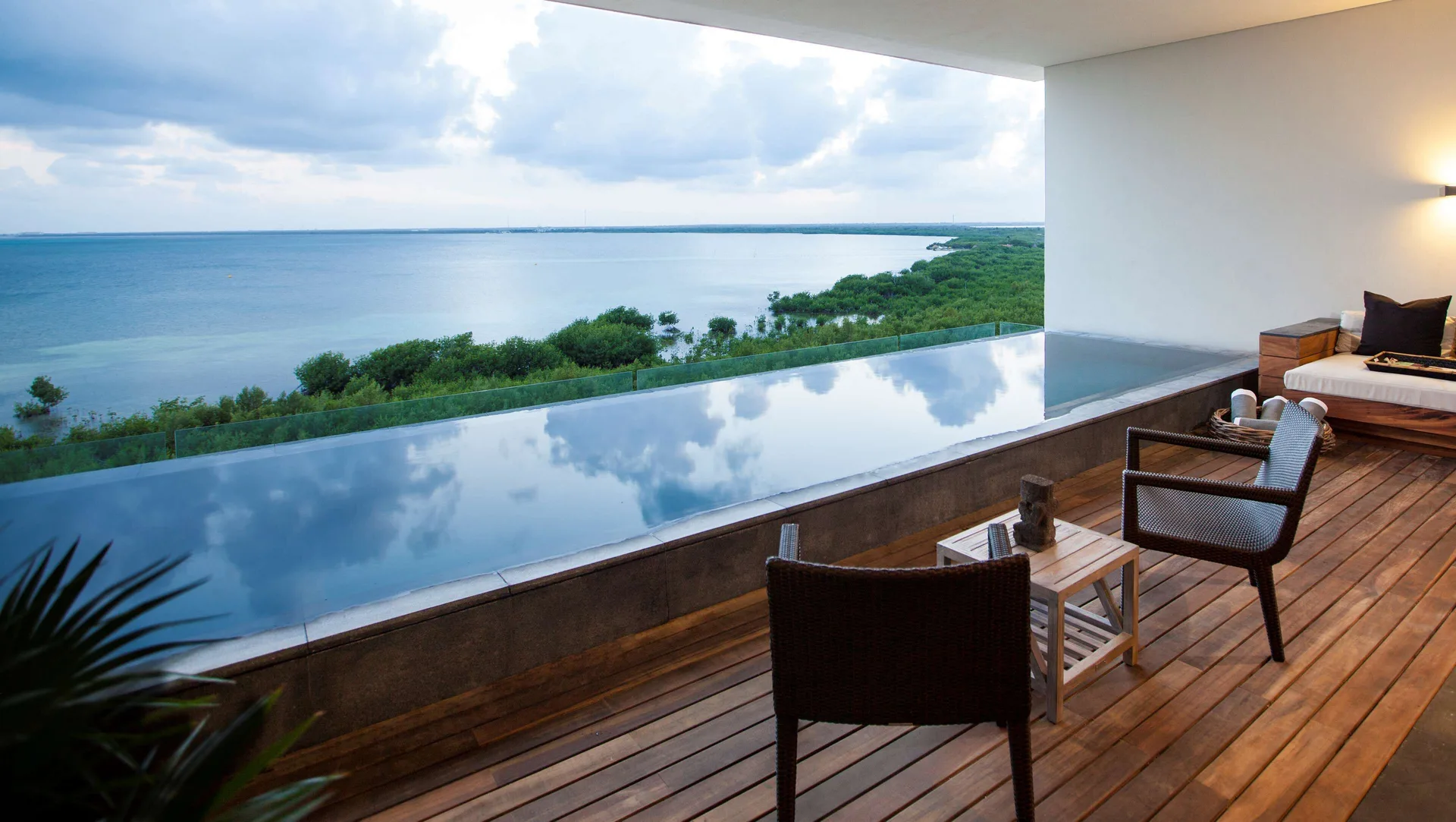 Master Suite terrace at Nizuc Resort and Spa with plunge pool, chairs and lagoon view.