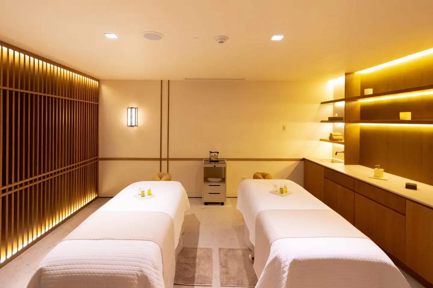 A spa treatment room with two massage tables at Nobu Hotel Los Cabos.