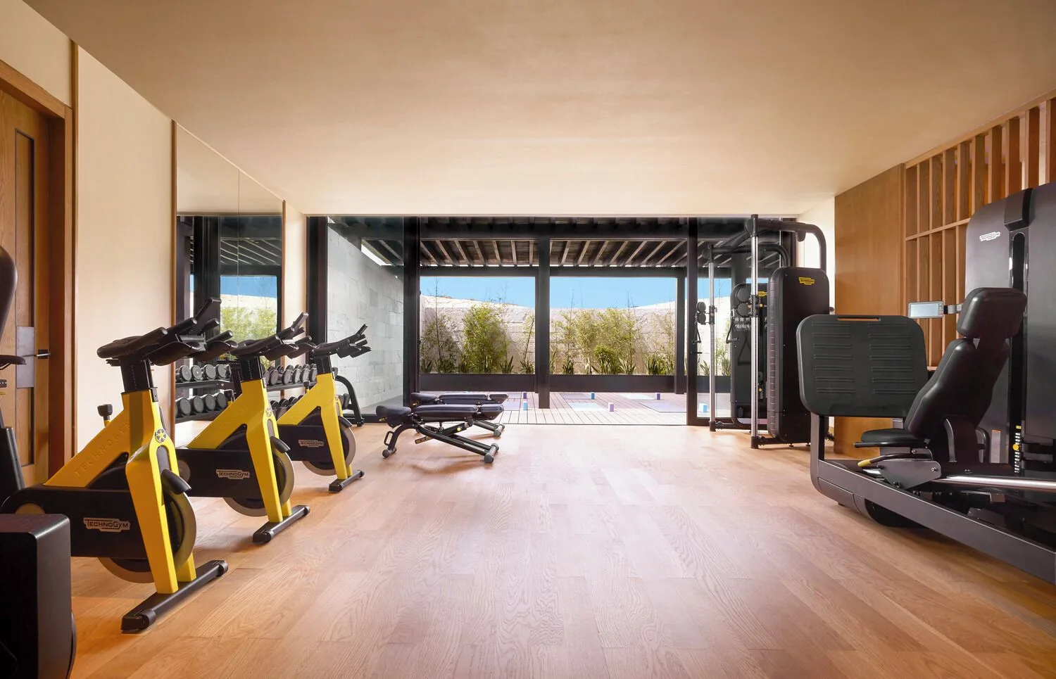 Fitness room with exercise bikes, weights and machines at Nobu Hotel Los Cabos.