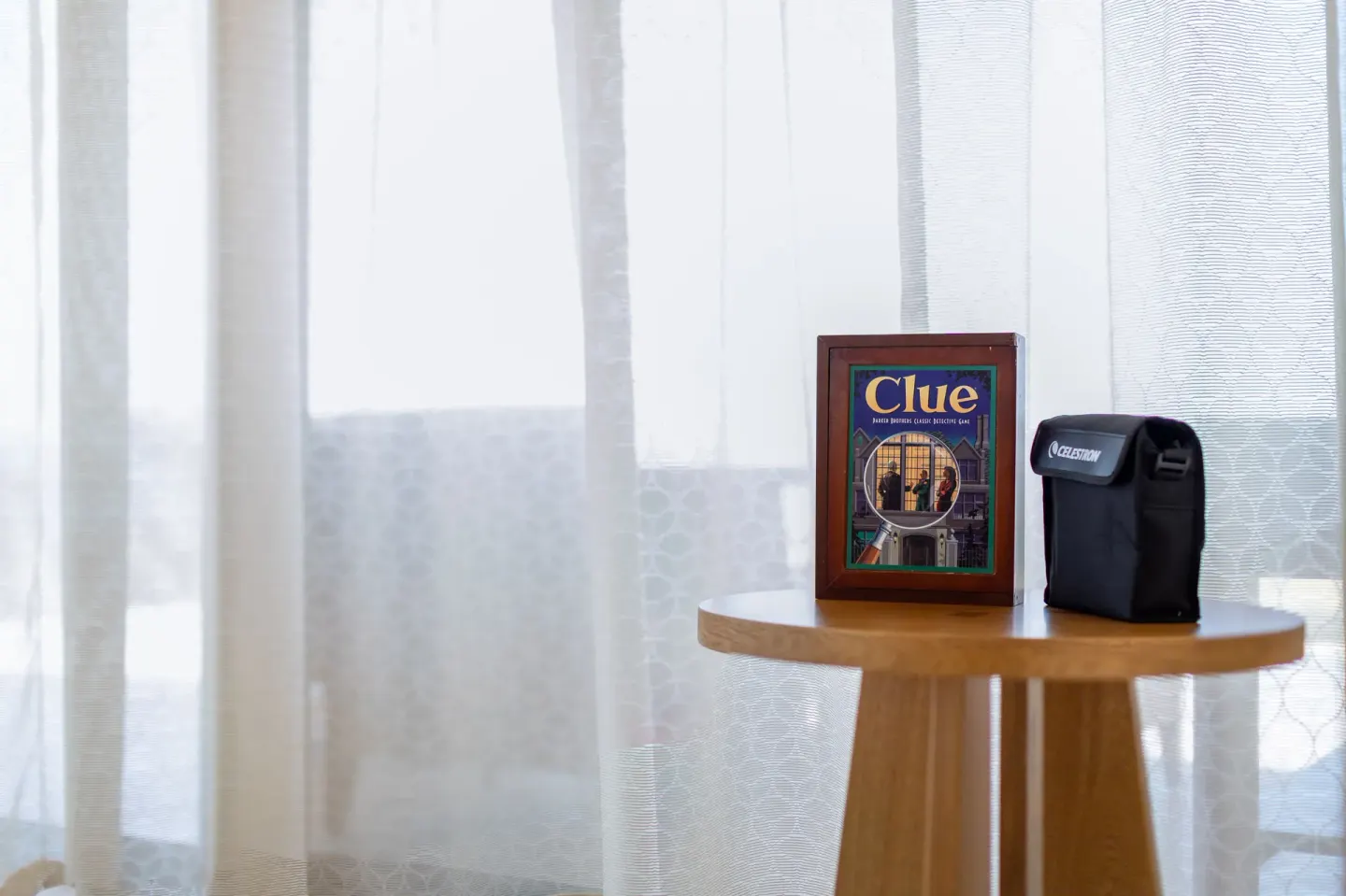 Board game and black case on a table by sheer curtains at Nobu Hotel Los Cabos.