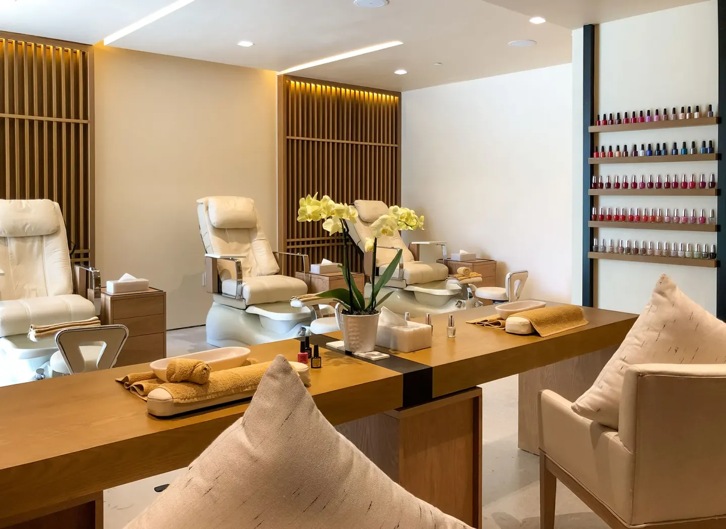 A nail salon with pedicure chairs and polish displays at Nobu Hotel Los Cabos.