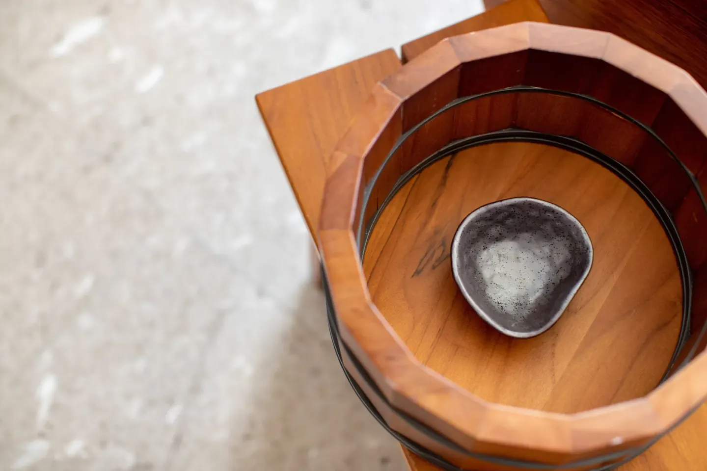 Close-up of a wooden bath bucket and bowl at Nobu Hotel Los Cabos.