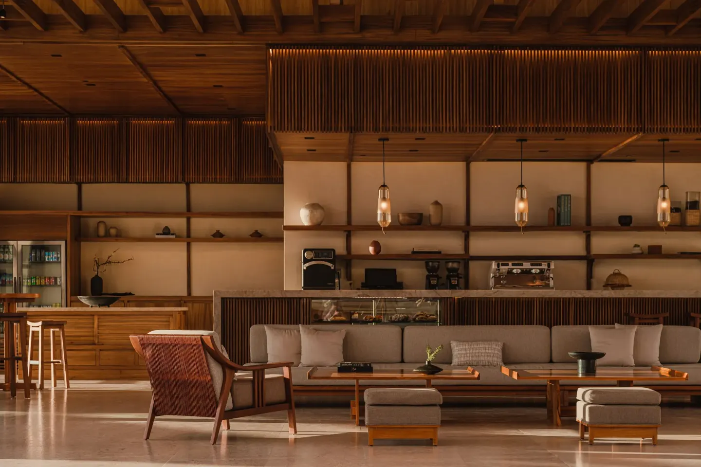 Cafe-style lounge with bar counter and sofas at Nobu Hotel Los Cabos.