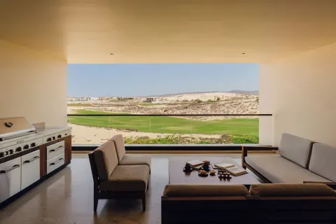 Asahi 2 Bedrooms covered terrace with sofas and outdoor grill at Nobu Hotel Los Cabos.