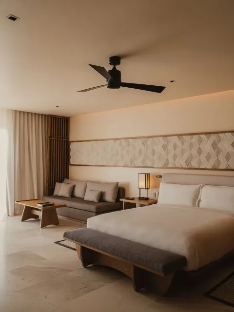 King bedroom with sofa seating in an Asahi 2 Bedrooms residence at Nobu Hotel Los Cabos.