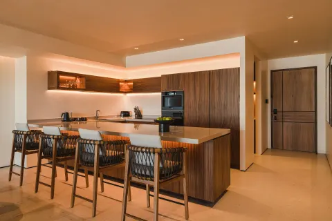 Kitchen island and bar seating in an Asahi 2 Bedrooms residence at Nobu Hotel Los Cabos.