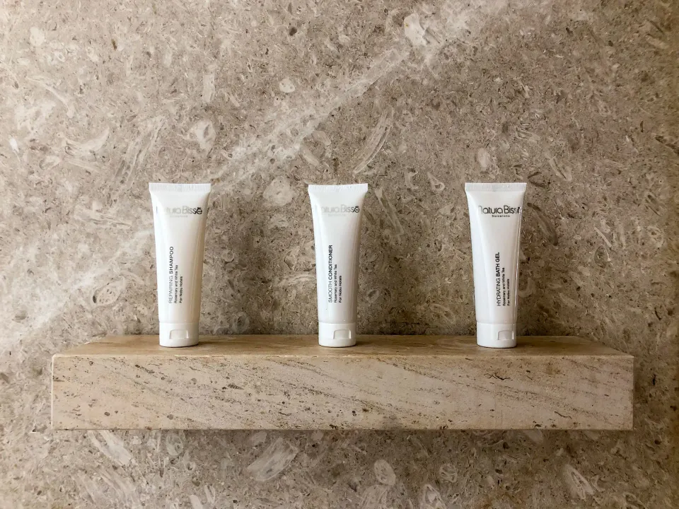 Deluxe Room bath amenities on a stone shower shelf at Nobu Hotel Los Cabos.