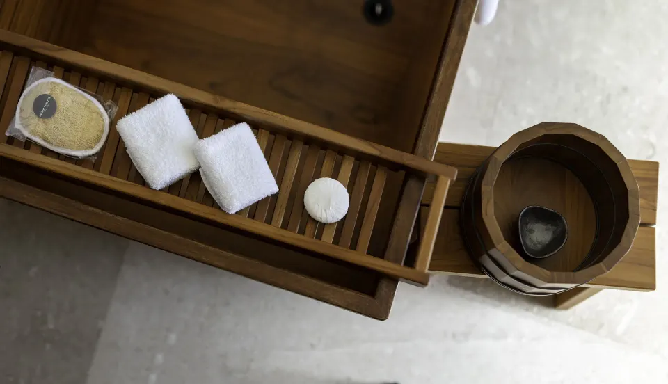 Deluxe Room bath tray with washcloths and wooden bucket at Nobu Hotel Los Cabos.