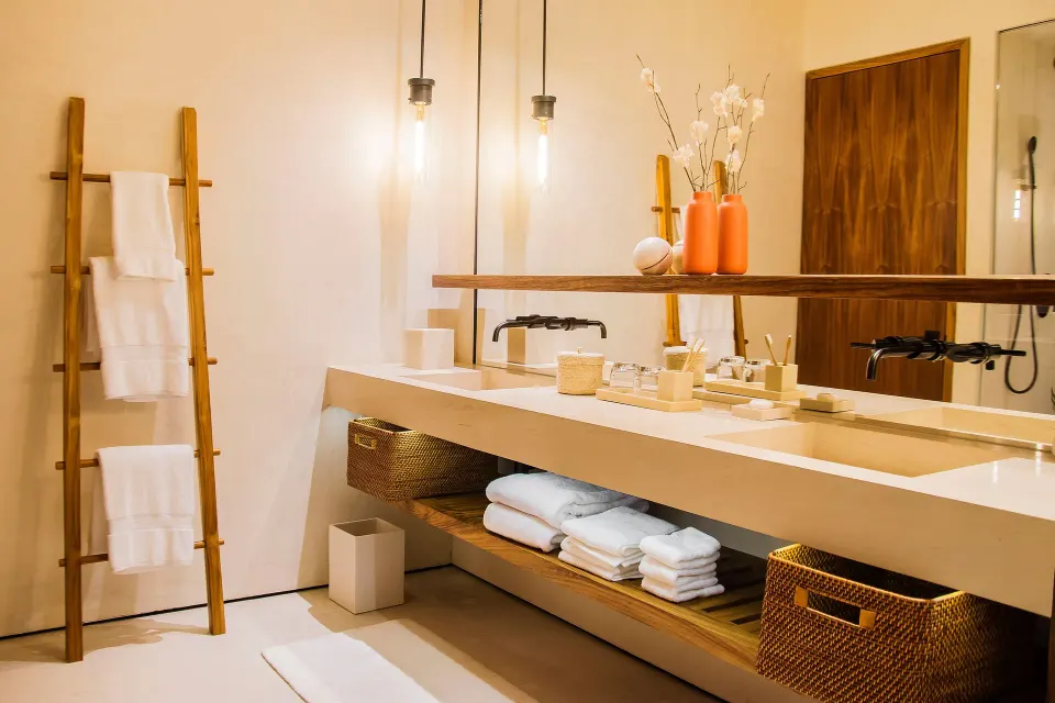 Deluxe Room bathroom vanity with sinks, towels and ladder rack at Nobu Hotel Los Cabos.