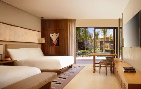 Deluxe Room with two beds, desk and garden view at Nobu Hotel Los Cabos.