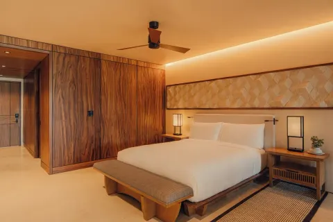 Hikari One Bedroom at Nobu Hotel Los Cabos with king bed, wood closets and warm bedside lighting.