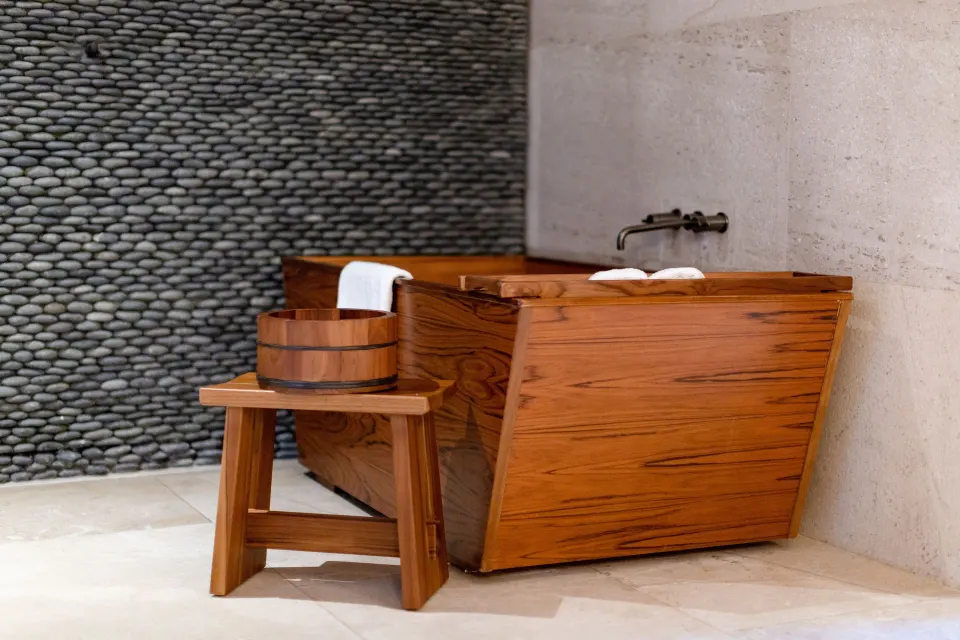 Junior Room bathroom wooden soaking tub with stool and bucket at Nobu Hotel Los Cabos.