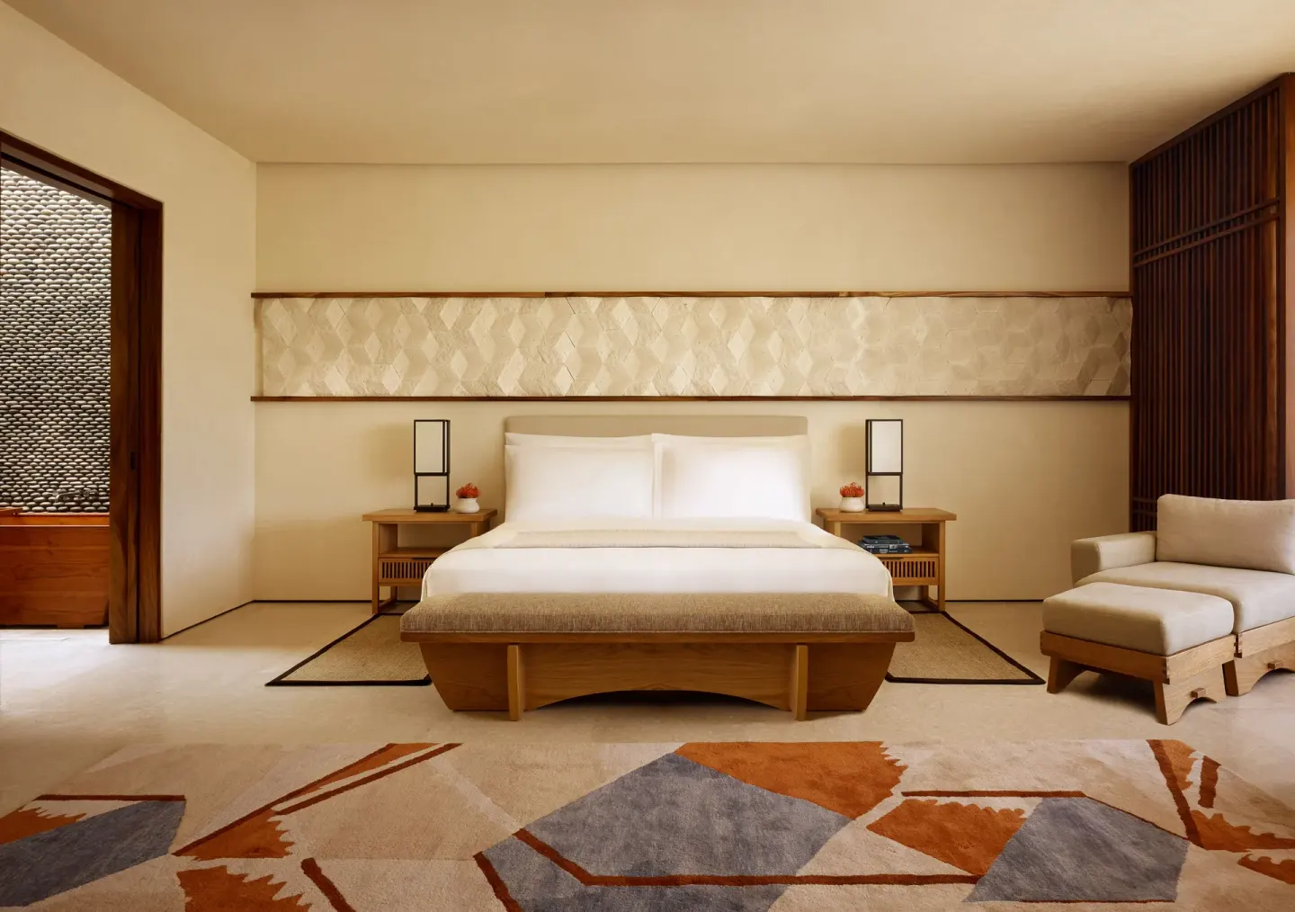 Junior Room king bed with bench and lounge chair at Nobu Hotel Los Cabos.