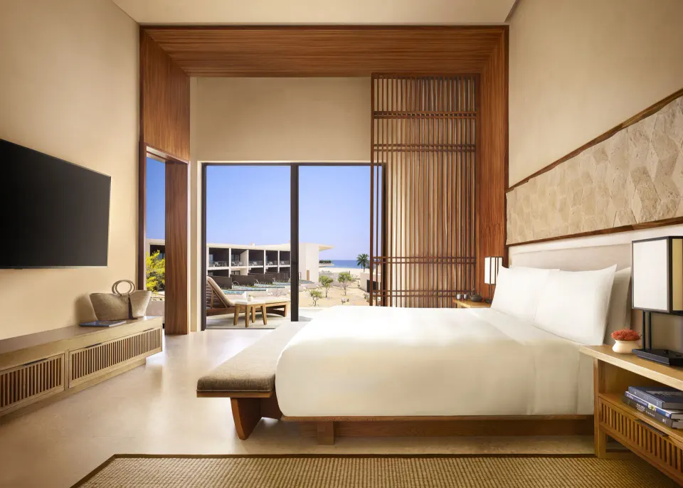 King bed and terrace view in a Luxury Room Ocean View at Nobu Hotel Los Cabos.