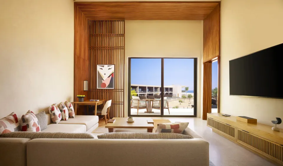Living area opening to a terrace in a Luxury Room Ocean View at Nobu Hotel Los Cabos.