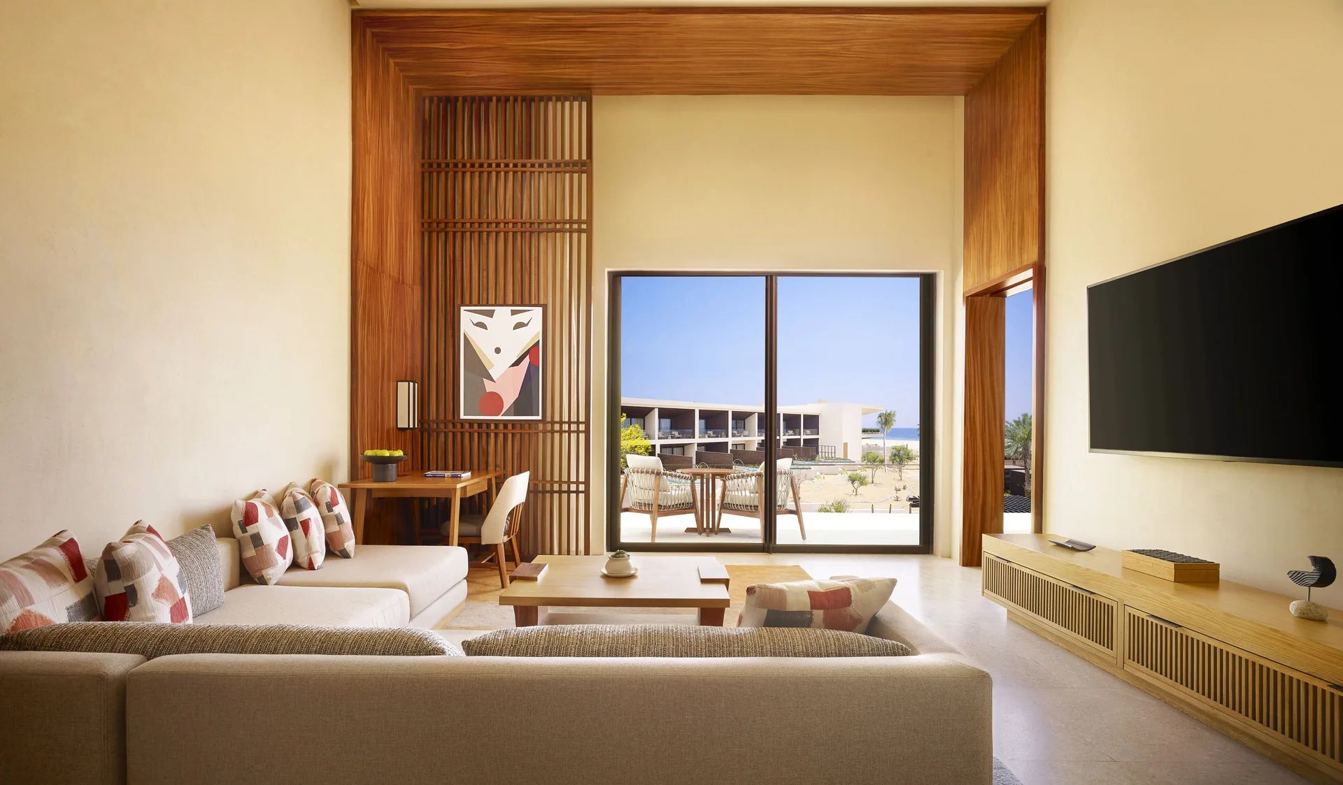 Living area opening to a terrace in a Luxury Room Ocean View at Nobu Hotel Los Cabos.