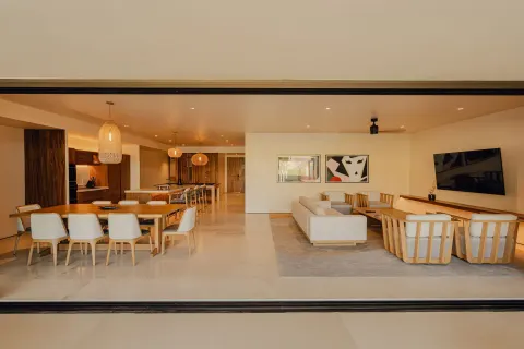 Sakyu 3 Bedrooms interior seen through wide terrace doors at Nobu Hotel Los Cabos.