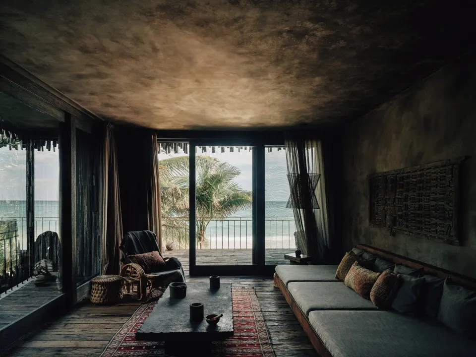 Cozy beachfront living room with sofa and ocean view at Nômade Temple Tulum