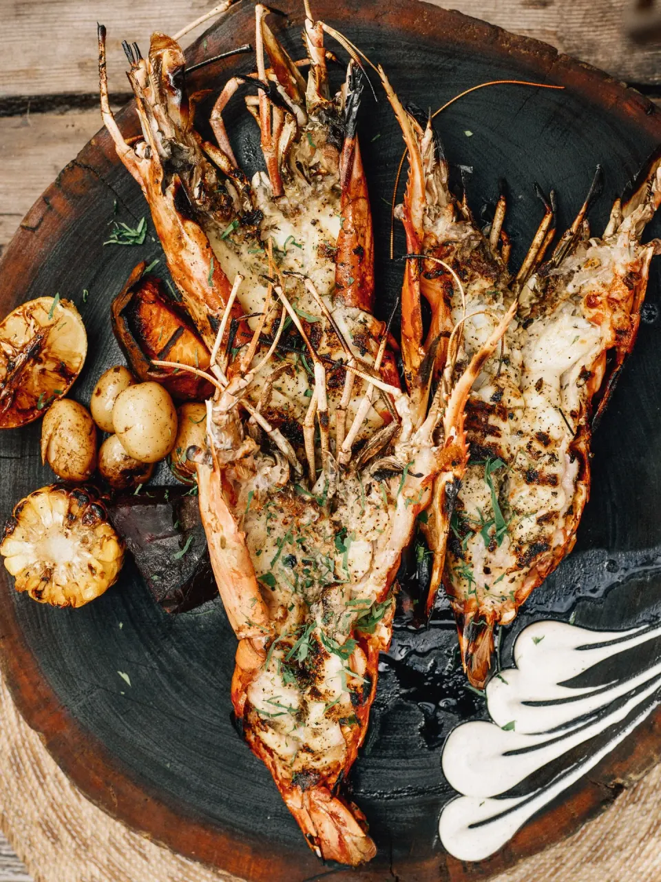 Grilled split prawns with potatoes and charred corn at Nômade Temple Tulum