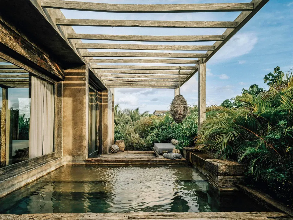 Private plunge pool and pergola terrace outside a Deluxe Garden View room at Nômade Temple Tulum
