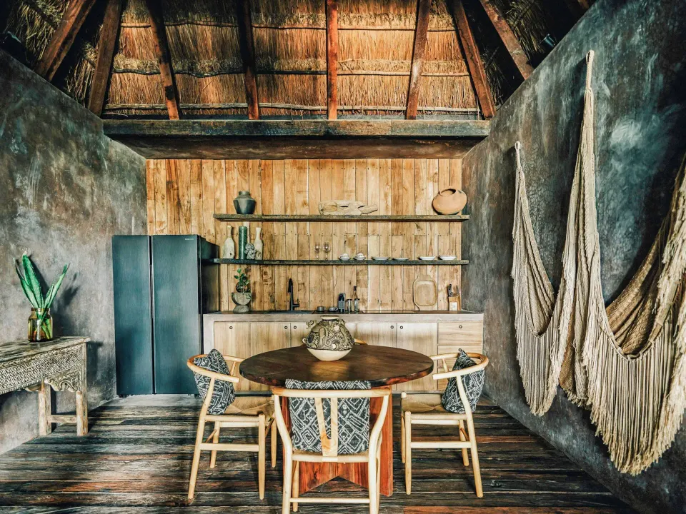 Dining table and kitchenette in a Deluxe Ocean View room at Nômade Temple Tulum