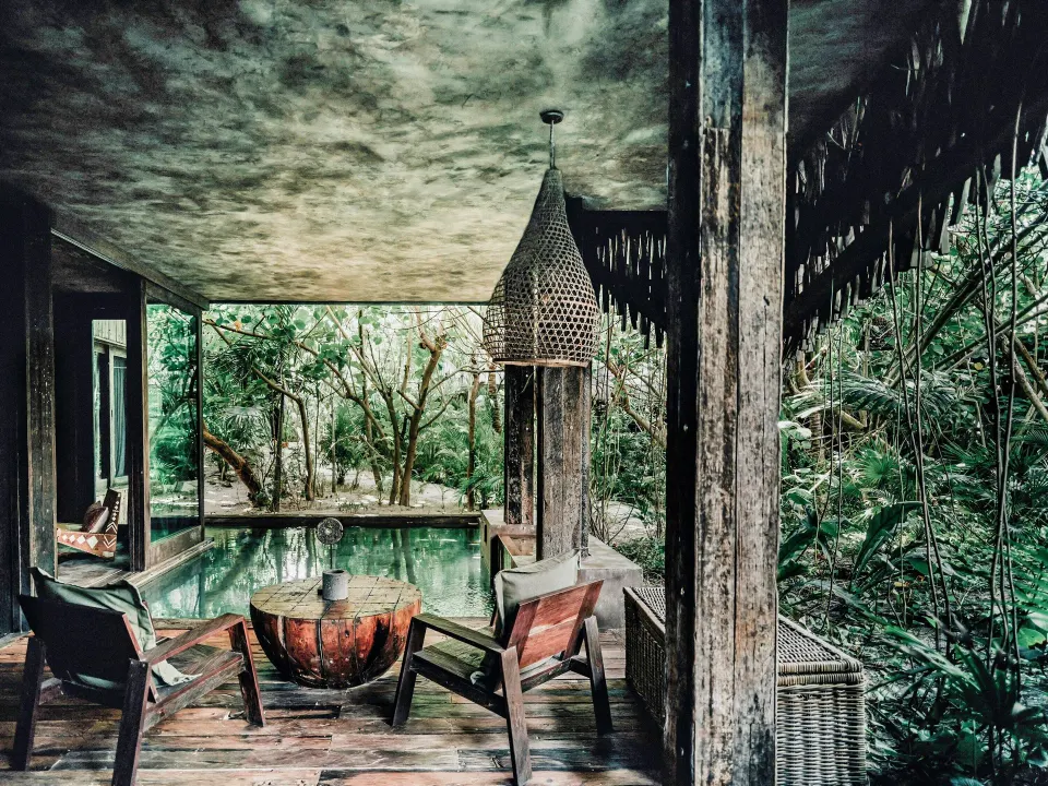 Outdoor seating area by the plunge pool with jungle view at Nômade Temple Tulum