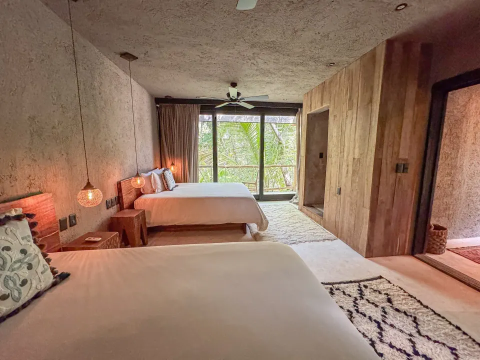 Two-bed deluxe guest room with balcony view at Nômade Temple Tulum