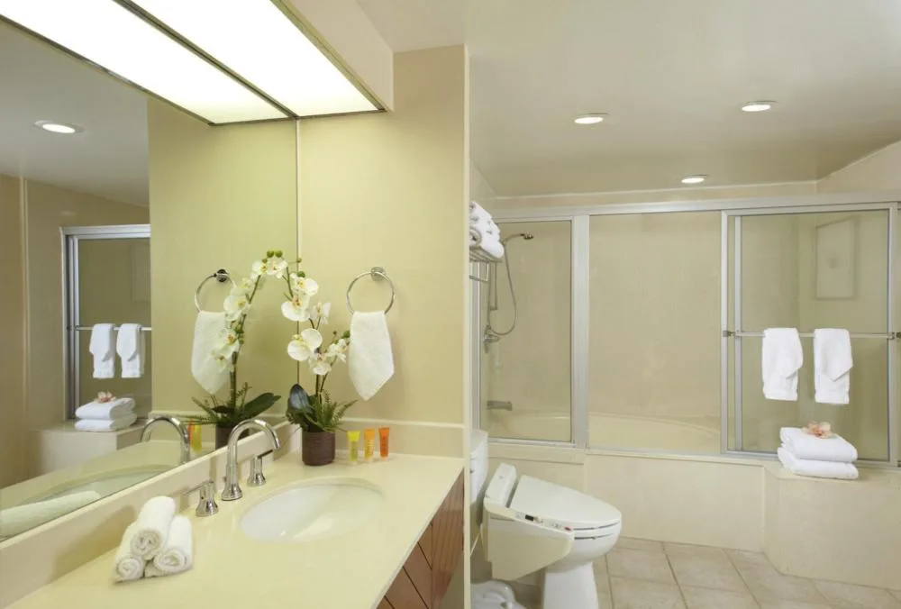 Hotel Standard Room bathroom with vanity and shower-tub at Oasis Hotel Waikiki.