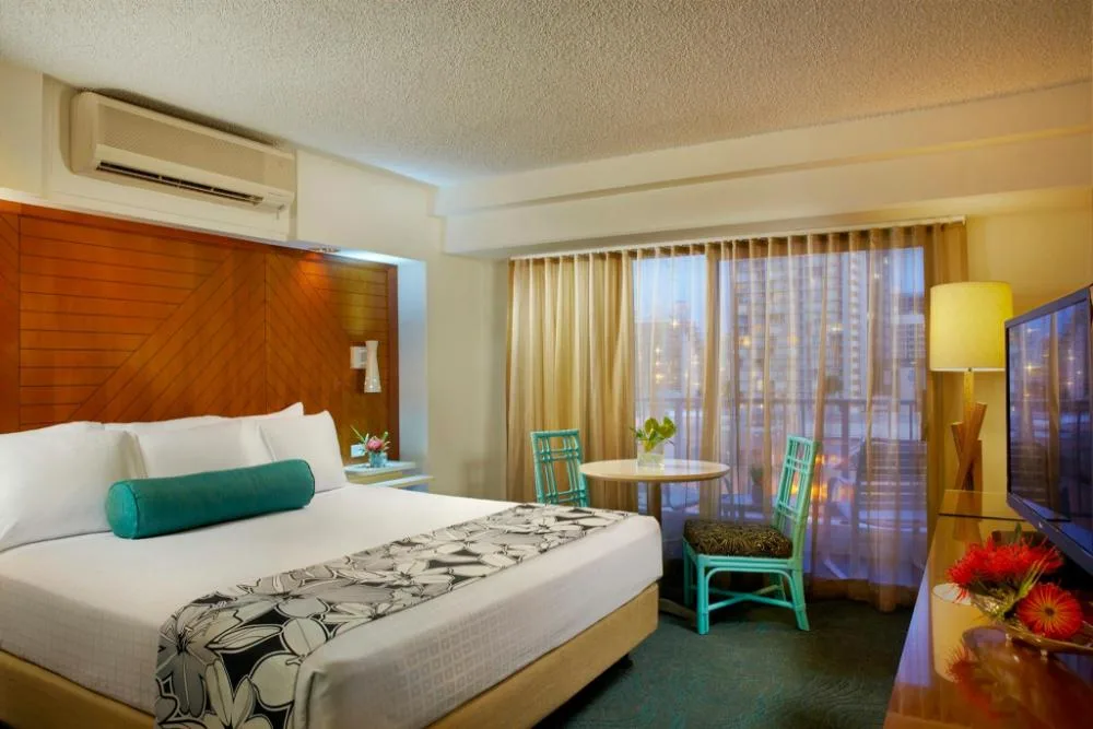 Hotel Standard Room with king bed and seating area at Oasis Hotel Waikiki.