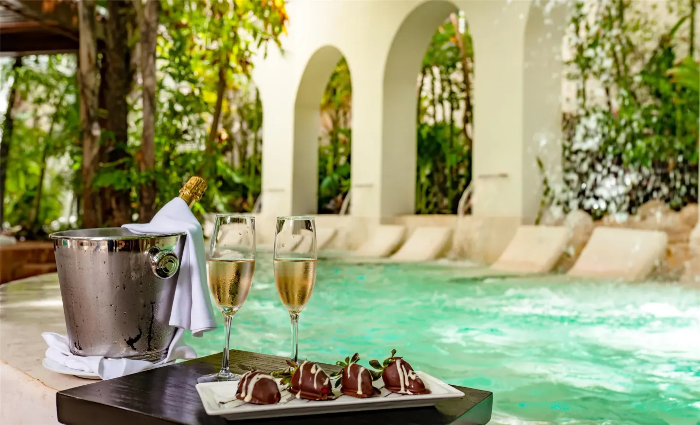Sparkling drinks, desserts, and a pool with loungers at Oasis Palm.