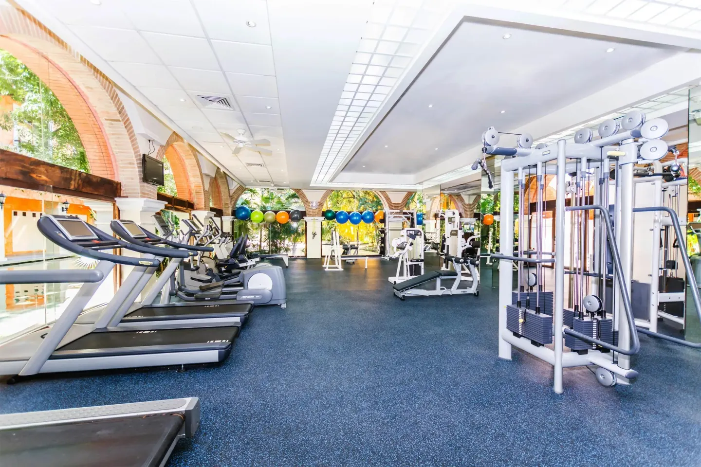 Fitness center with treadmills and weight machines at Occidental at Xcaret Destination.