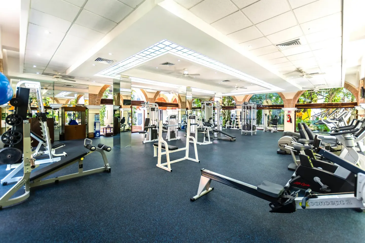 Spacious gym with weight machines and cardio equipment at Occidental at Xcaret Destination.