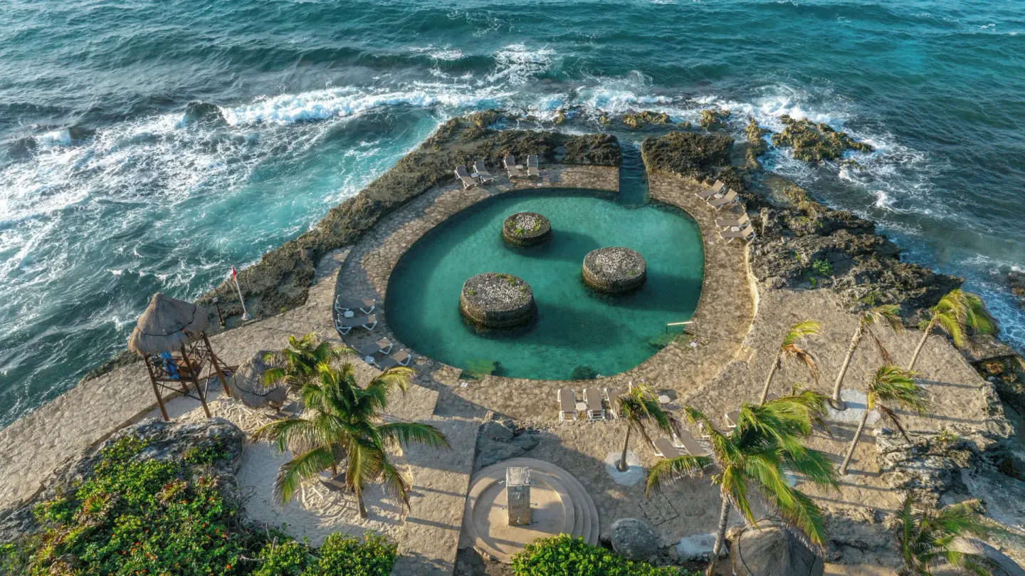 Aerial view of the oceanfront natural pool at Occidental at Xcaret Destination.