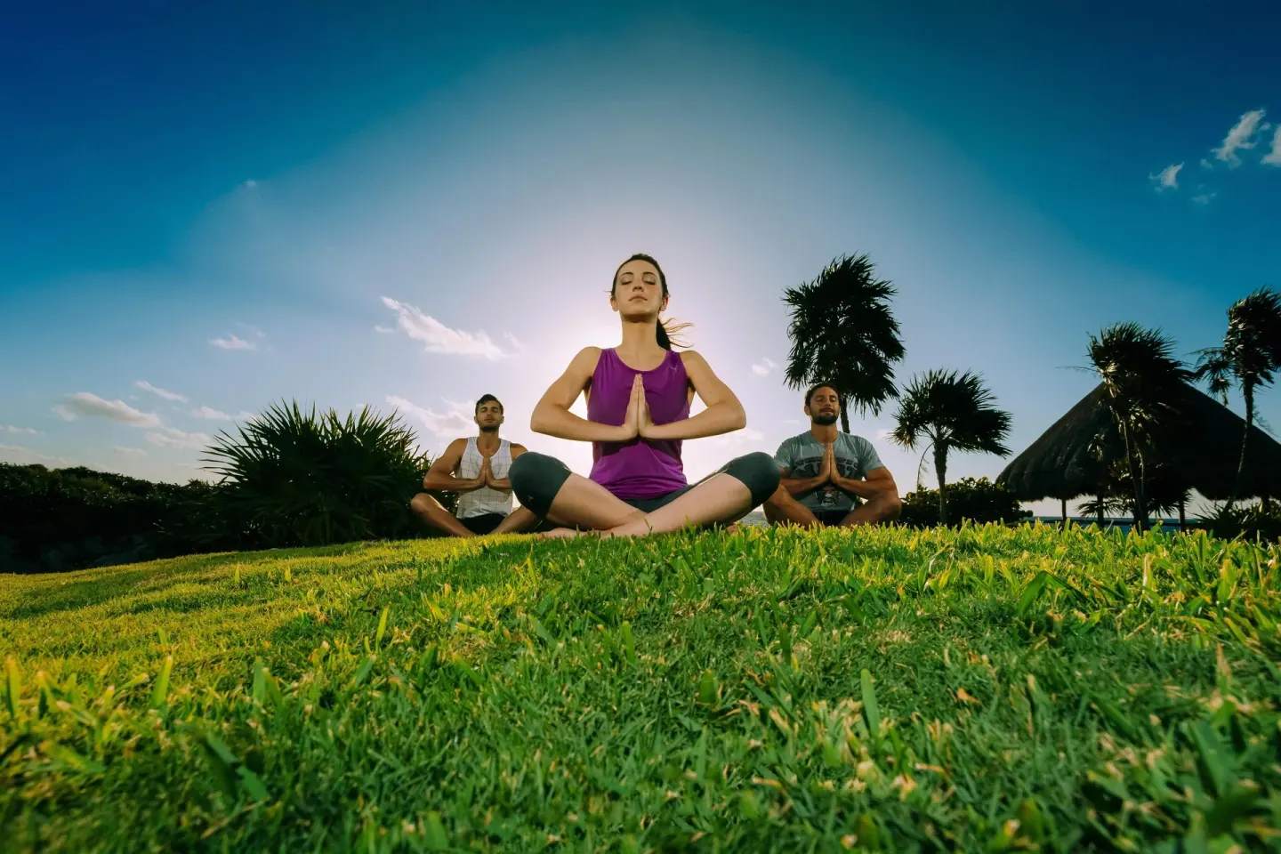 Outdoor yoga session on the grass at Occidental at Xcaret Destination.
