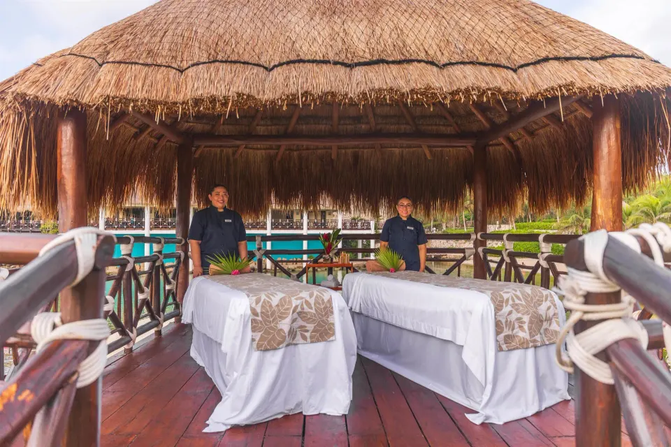 Two massage tables stand under a thatched spa palapa at Occidental at Xcaret Destination.