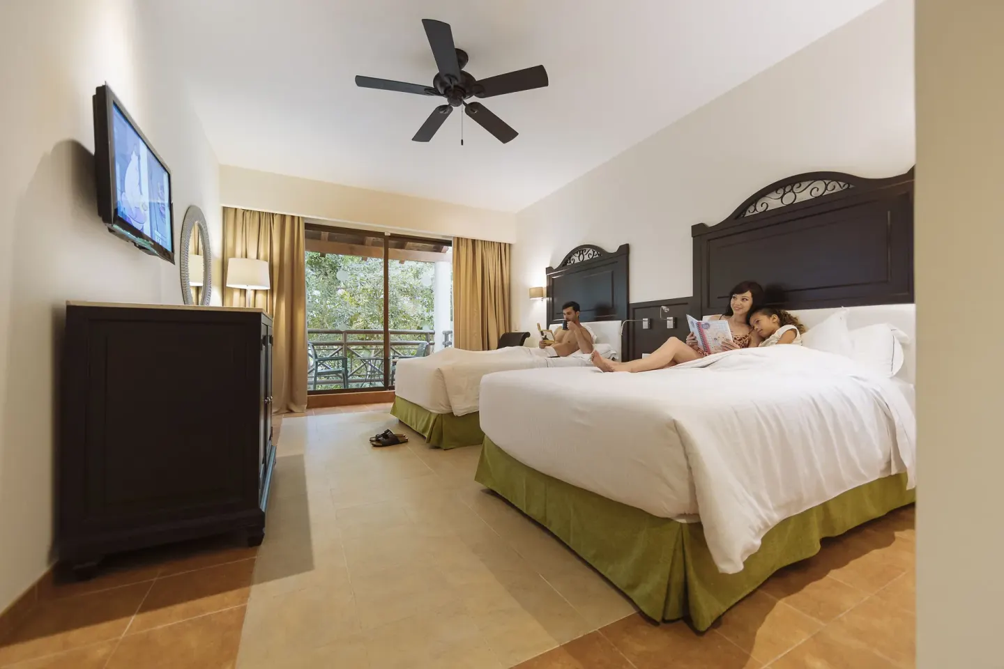 Deluxe Room with two beds, TV and balcony view at Occidental at Xcaret Destination.