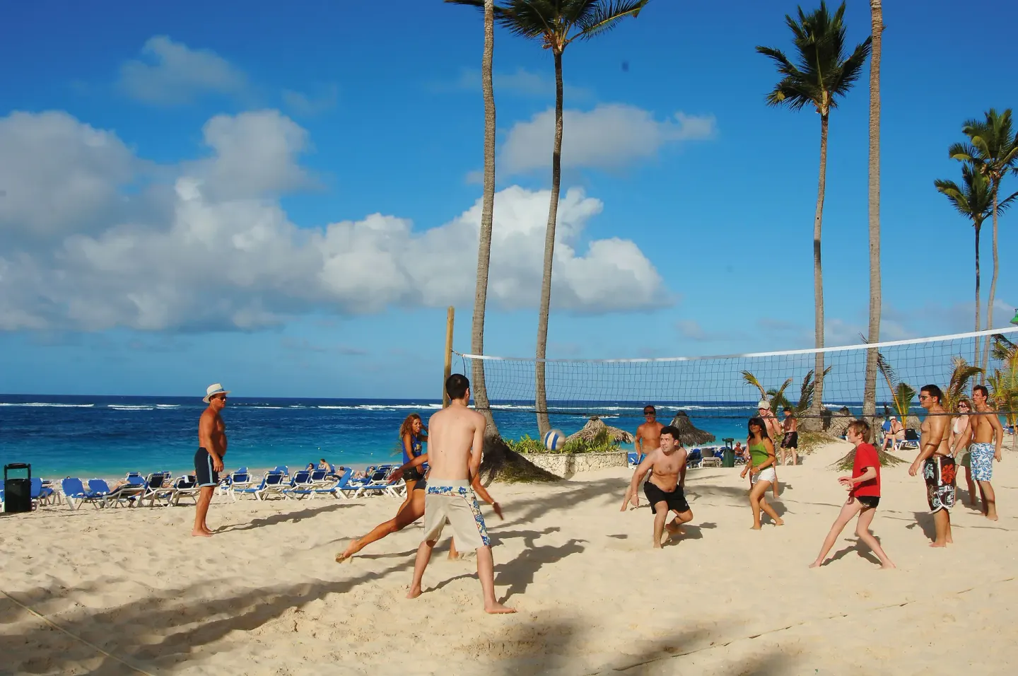 Guests play beach volleyball on the sand by the sea at Occidental Caribe.