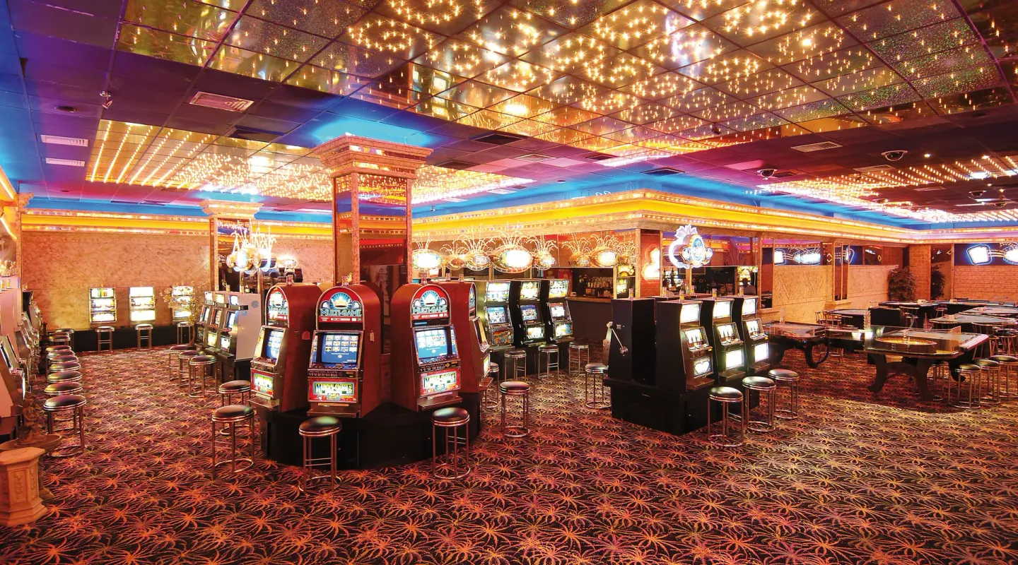 Casino floor with slot machines and bright ceiling lights at Occidental Caribe.