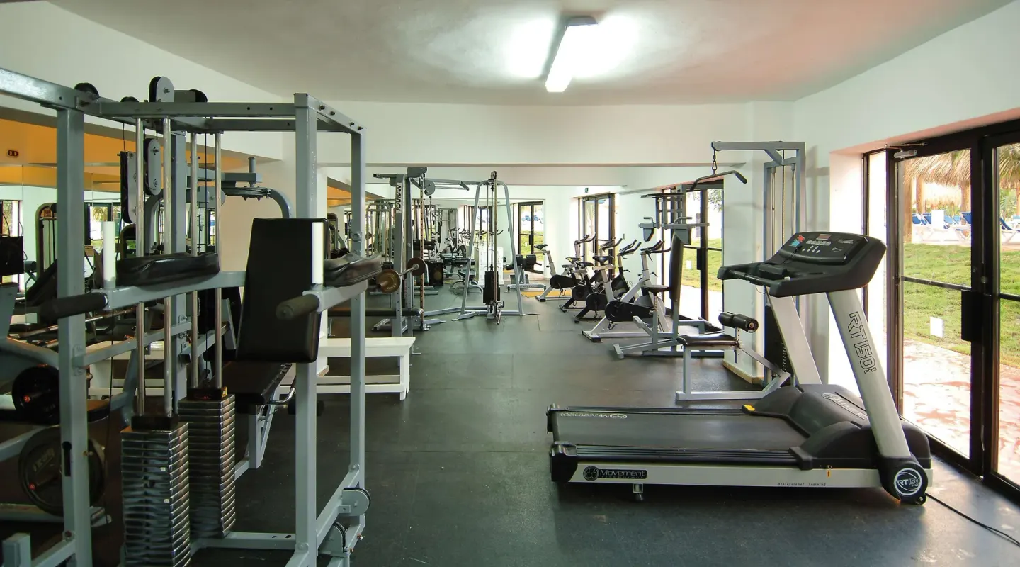Treadmill and weight machines in the fitness center at Occidental Caribe.