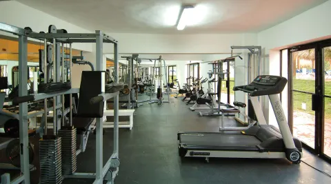 Treadmill and weight machines in the fitness center at Occidental Caribe.