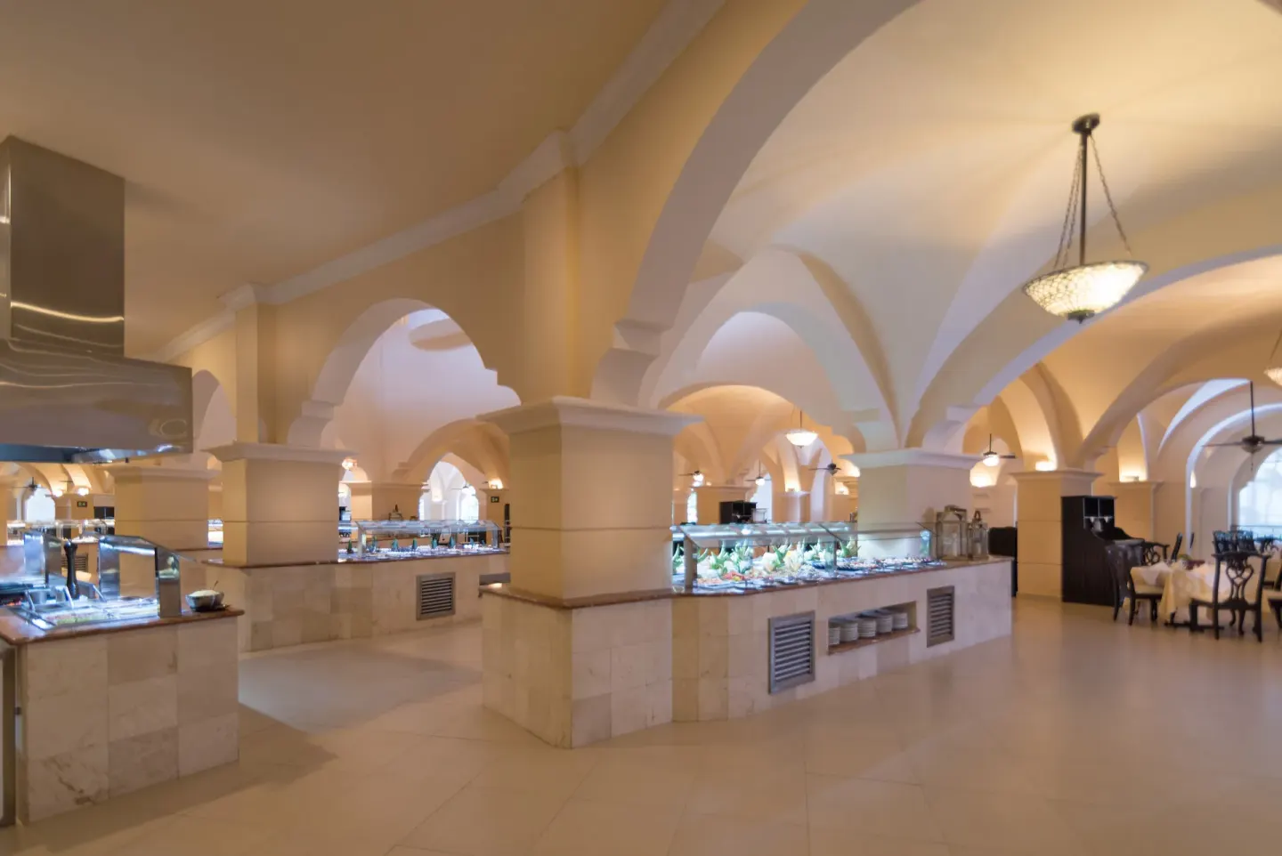 Buffet counters beneath vaulted arches in a dining room at Occidental Caribe.