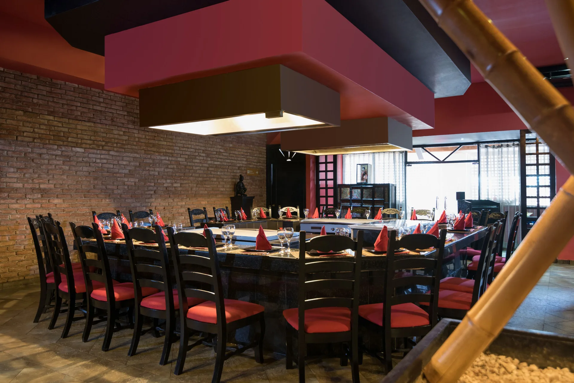 Hibachi-style dining table with red napkins inside Occidental Caribe.