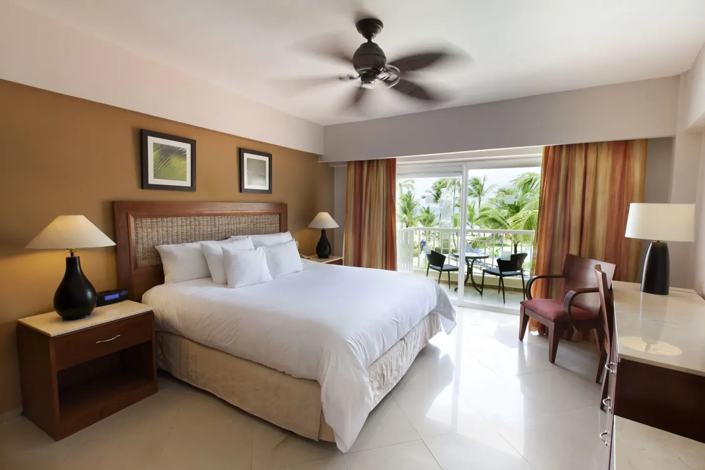 Superior Room with king bed and balcony seating at Occidental Caribe.
