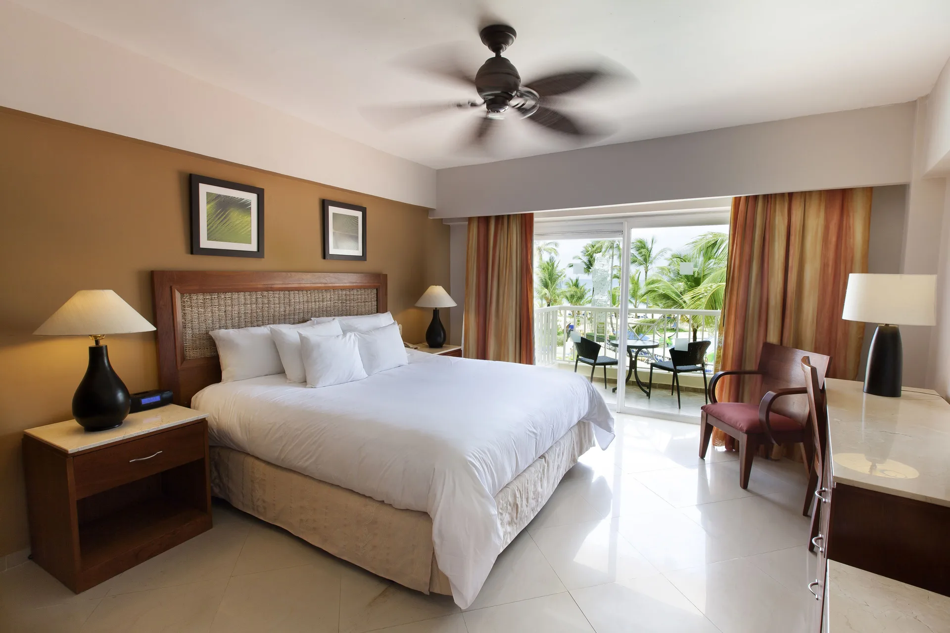 Superior Room with king bed and balcony seating at Occidental Caribe.