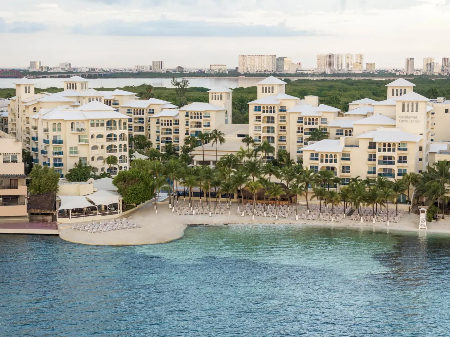 Aerial view of the beachfront resort buildings and shoreline at Occidental Costa Cancún.
