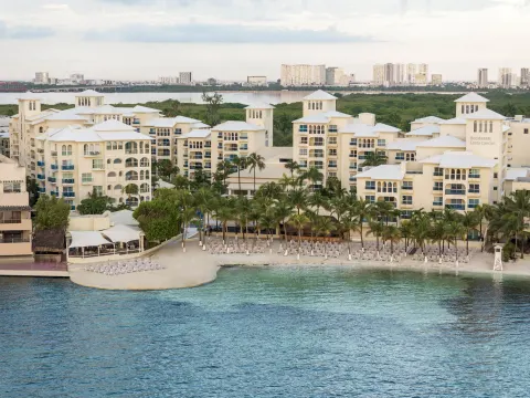 Aerial view of the beachfront resort buildings and shoreline at Occidental Costa Cancún.