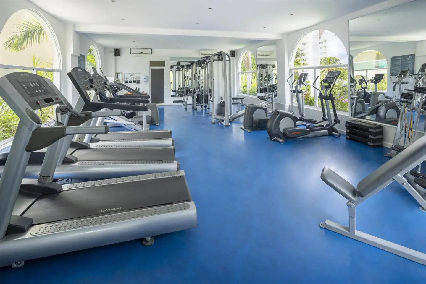 Fitness center with treadmills and exercise machines at Occidental Costa Cancún.