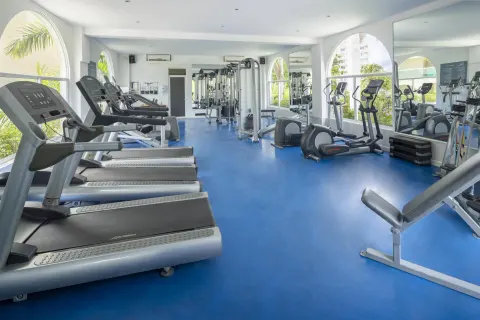 Fitness center with treadmills and exercise machines at Occidental Costa Cancún.